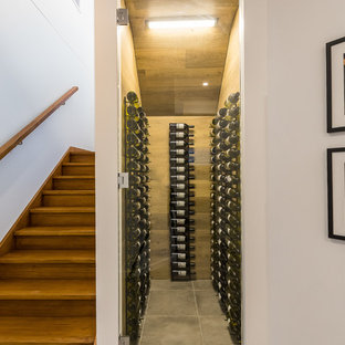 Design ideas for a contemporary wine cellar in Brisbane with display racks and grey floor.