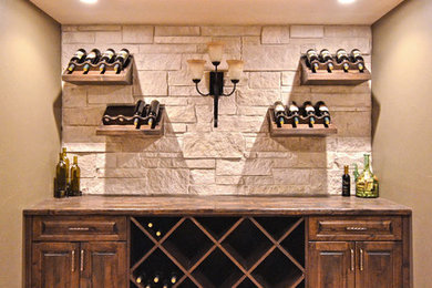 Large tuscan concrete floor wine cellar photo in Denver with storage racks