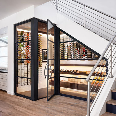 Example of a mid-sized trendy light wood floor and beige floor wine cellar design in Austin with display racks