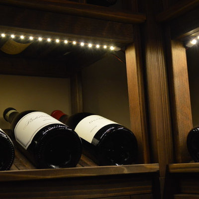 Inspiration for a mid-sized craftsman wine cellar remodel in Orange County with display racks