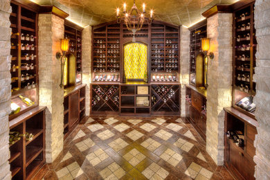 Large tuscan ceramic tile wine cellar photo in Kansas City with storage racks