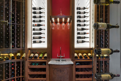 Classic wine cellar in Phoenix with medium hardwood flooring, storage racks and a feature wall.