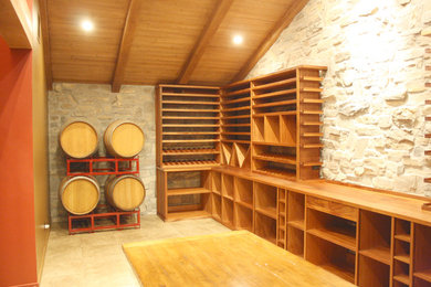 Inspiration for a large rustic ceramic tile wine cellar remodel in Los Angeles with storage racks