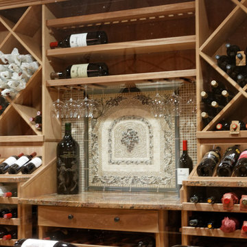 custom wine tasting counter with porcelain backsplash featuring a grape design.