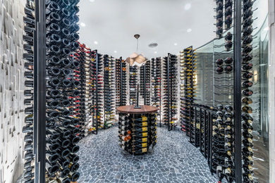 Example of a large trendy gray floor wine cellar design in Columbus with display racks