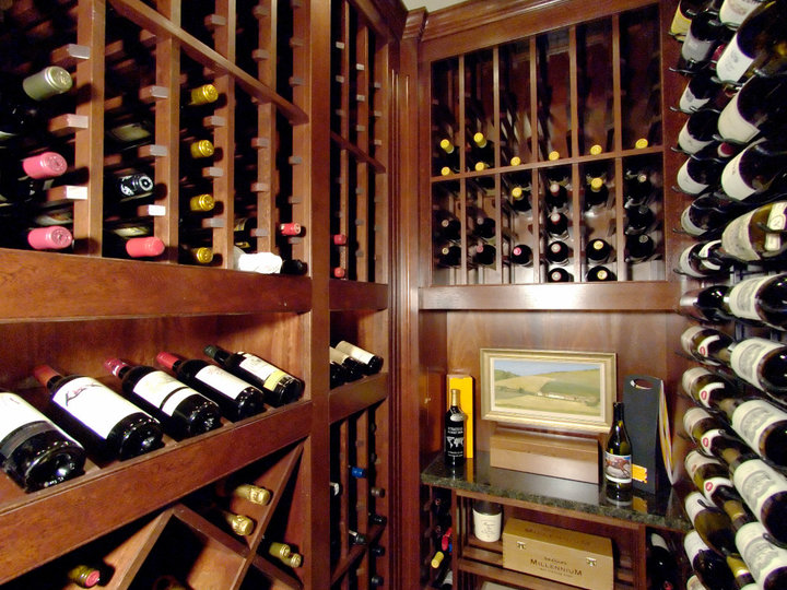 Huge elegant ceramic tile wine cellar photo with display racks