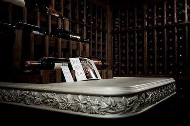 Example of a mid-sized classic slate floor wine cellar design in New York with display racks
