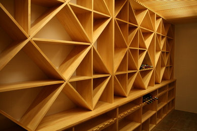 Photo of a medium sized traditional wine cellar in Other with cube storage.