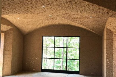 Wine cellar - mid-sized rustic limestone floor and beige floor wine cellar idea in Other