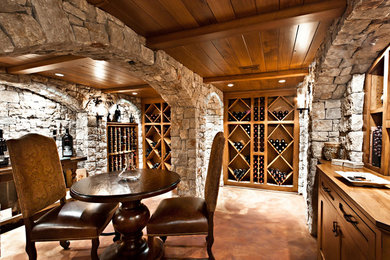 Wine cellar - large rustic wine cellar idea in Other with diamond bins