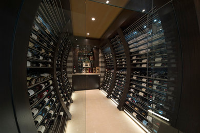 This is an example of a medium sized contemporary wine cellar in Vancouver with limestone flooring and storage racks.