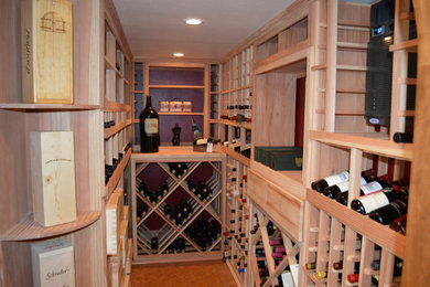 Example of a small classic wine cellar design in Orange County with storage racks