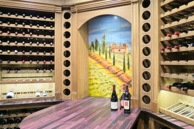 Wine cellar - mid-sized traditional slate floor wine cellar idea in Denver with display racks