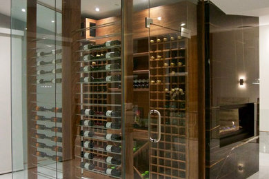 Wine cellar - small contemporary wine cellar idea in Vancouver with storage racks