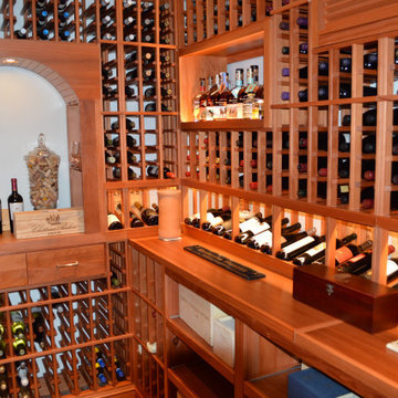 Home Wine Cellar With Wooden Wine Racks by Coastal's Wine Cellar Contractors