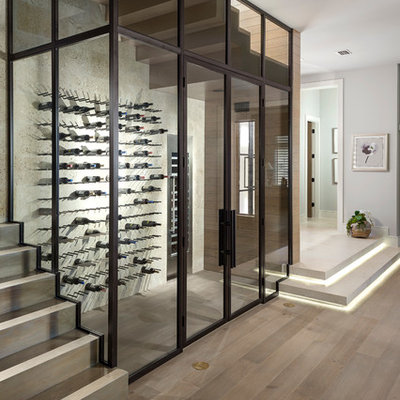Wine cellar - contemporary light wood floor wine cellar idea in Orlando with storage racks