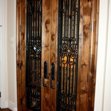Knotty Alder Custom Wine Cellar Door with a Custom Iron Design
