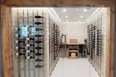 Inspiration for a mid-sized modern porcelain tile and gray floor wine cellar remodel in Raleigh with storage racks