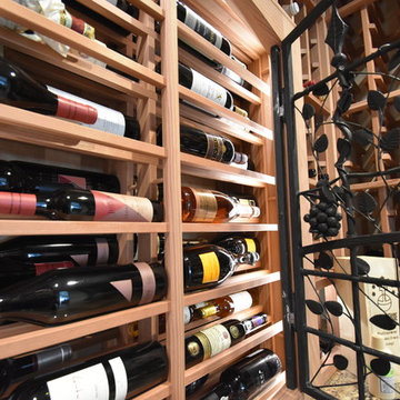 Laguna Hills Orange Small County Custom Wine Cellar with Wrought Iron Door