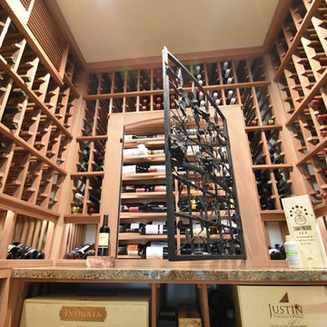 Laguna Hills Orange Small County Custom Wine Cellar with Wrought Iron Door