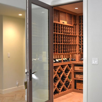 Laguna Hills Orange Small County Custom Wine Cellar with Wrought Iron Door
