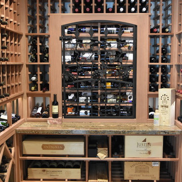Laguna Hills Orange Small County Custom Wine Cellar with Wrought Iron Door