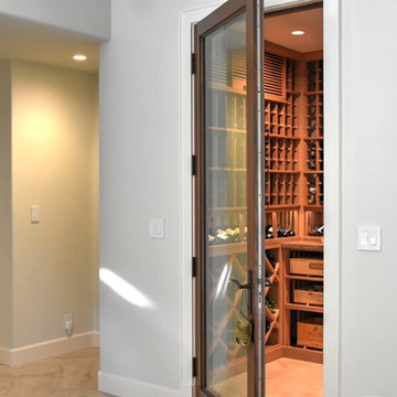Laguna Hills Orange Small County Custom Wine Cellar with Wrought Iron Door