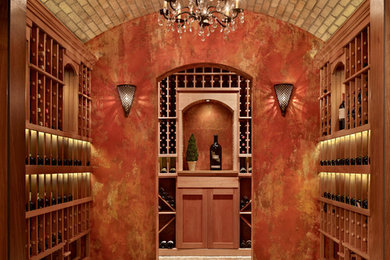 Example of a mid-sized tuscan terra-cotta tile wine cellar design in Seattle with display racks