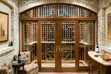 Example of a mid-sized classic travertine floor wine cellar design in Toronto with display racks