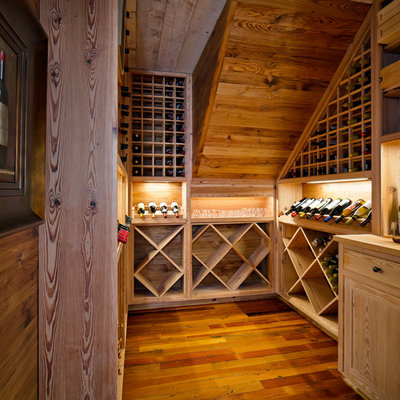 Wine cellar - mid-sized traditional medium tone wood floor wine cellar idea in New Orleans with diamond bins