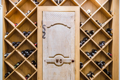 Wine cellar - transitional medium tone wood floor wine cellar idea in Cleveland