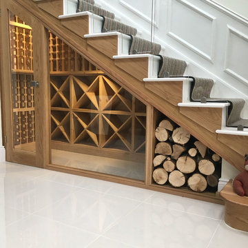 Luxury under stairs wine cellar in modern private home with a glass front