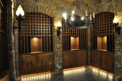 Wine cellar - large mediterranean gray floor wine cellar idea in Portland with storage racks