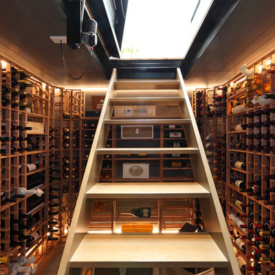 Example of a small trendy wine cellar design in Auckland with storage racks