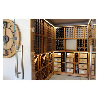 Medium sized wine cellar with glass door opening in West Sussex