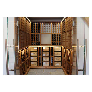 Medium sized wine cellar with glass door opening in West Sussex