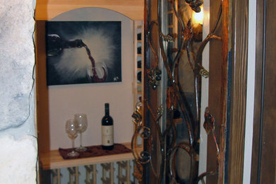 Mid-sized tuscan porcelain tile wine cellar photo in Denver with storage racks
