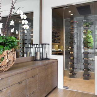 Immagine di una grande cantina contemporanea con pavimento in legno massello medio, portabottiglie a vista e pavimento beige