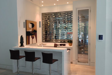 Mid-sized minimalist light wood floor and beige floor wine cellar photo in Miami with display racks