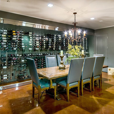 Wine cellar - contemporary concrete floor wine cellar idea in San Francisco with display racks
