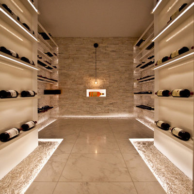 Inspiration for a large contemporary marble floor wine cellar remodel in Toronto with display racks
