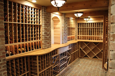 Inspiration for a huge rustic brick floor wine cellar remodel in Boston with storage racks