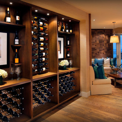 Inspiration for a mid-sized contemporary medium tone wood floor and yellow floor wine cellar remodel in Miami with storage racks
