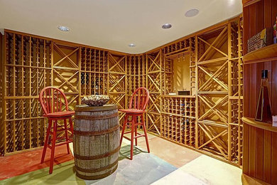 Example of a mid-sized classic limestone floor and beige floor wine cellar design in Orlando with storage racks