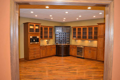 Mid-sized elegant medium tone wood floor and brown floor wine cellar photo in Indianapolis with display racks