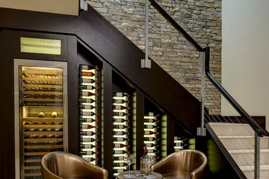 Small classic wine cellar in Orlando with display racks and beige floors.
