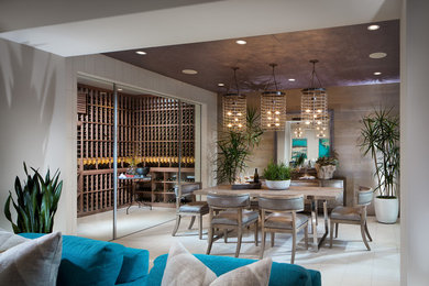Photo of a medium sized contemporary wine cellar in Orange County with travertine flooring and storage racks.