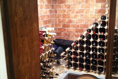 Wine cellar - mid-sized traditional wine cellar idea in New York with storage racks