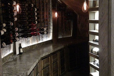 Wine cellar - mid-sized mediterranean concrete floor and gray floor wine cellar idea in Salt Lake City with diamond bins