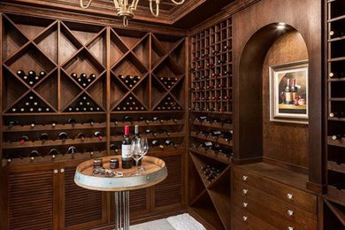 Example of a large transitional wine cellar design in Vancouver with storage racks